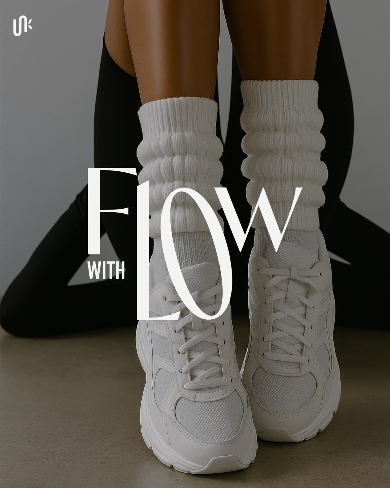 Vertical FLOW WITH wordmark over white sneakers and black leggings