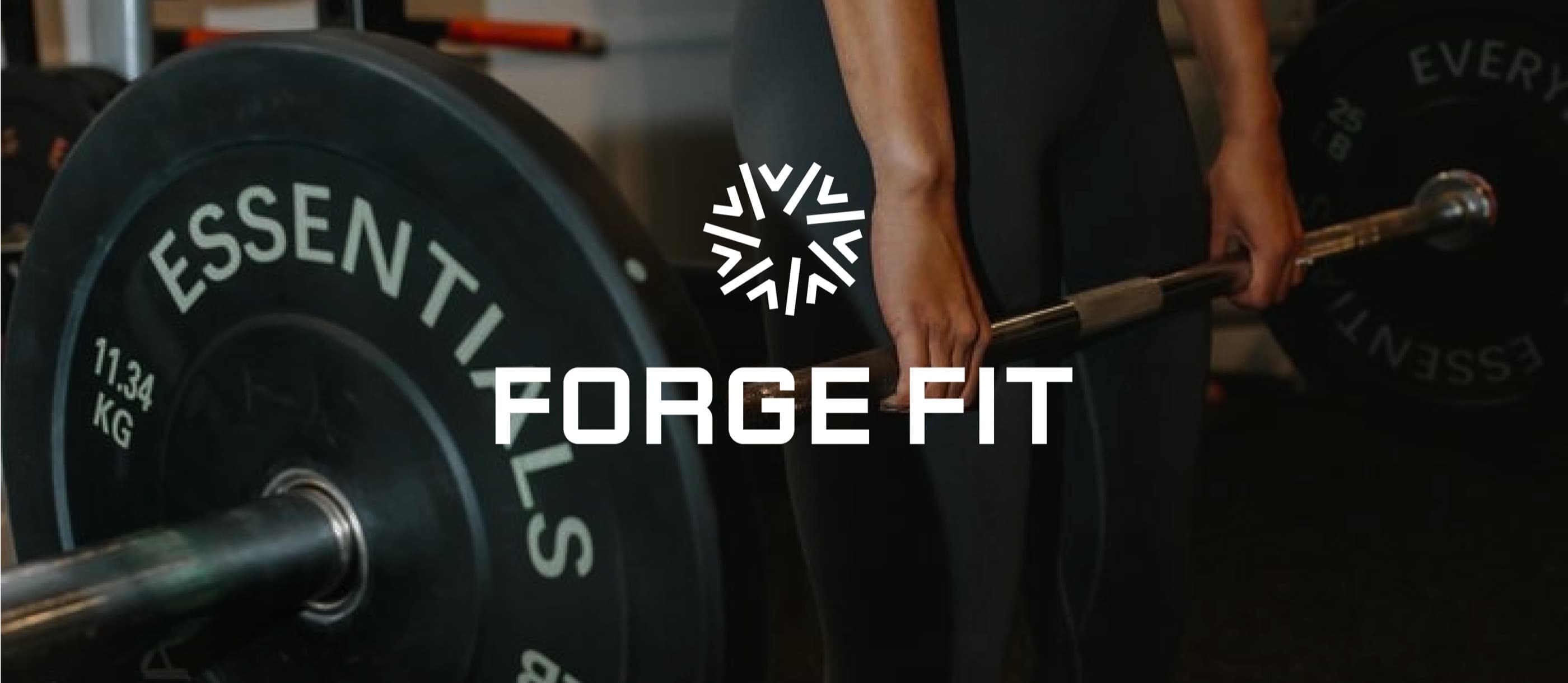 Forge Fit sunburst mark and wordmark over a deadlift in a dark gym