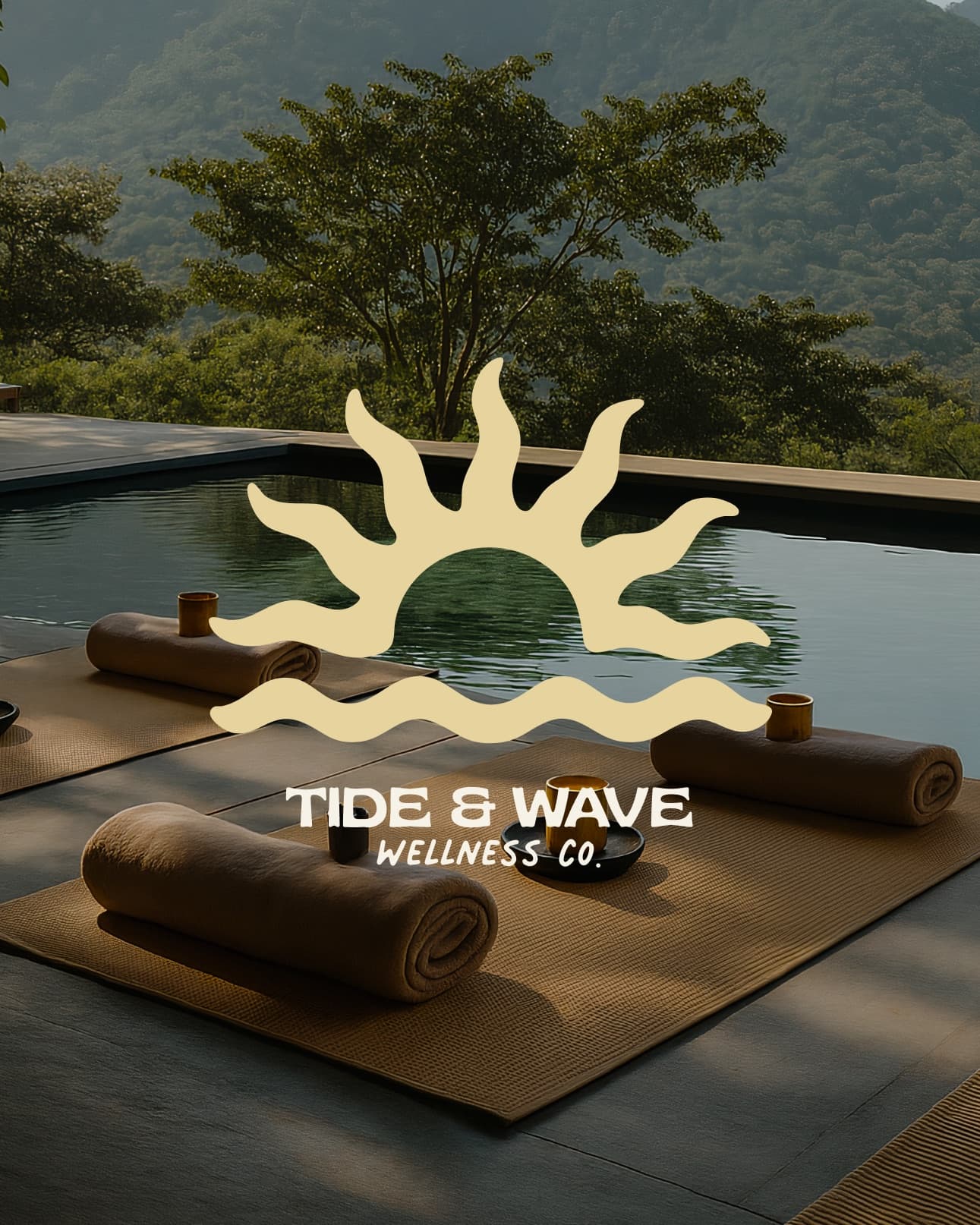Tide And Wave Wellness sun and wave logo over yoga mats on a poolside patio overlooking hills