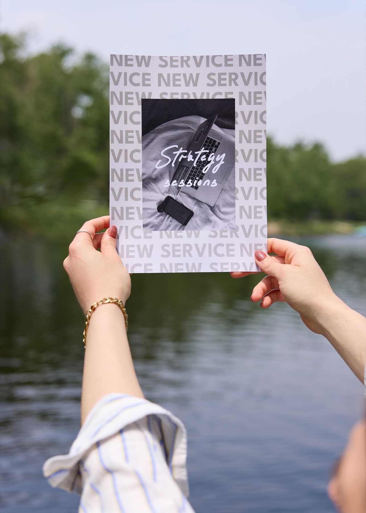 Jaia Studio Strategy Sessions print held outdoors beside the water