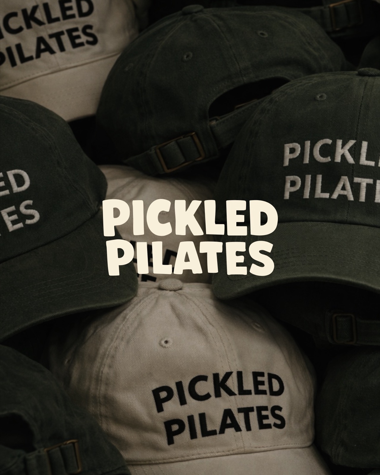Stack of Pickled Pilates green and cream embroidered baseball caps